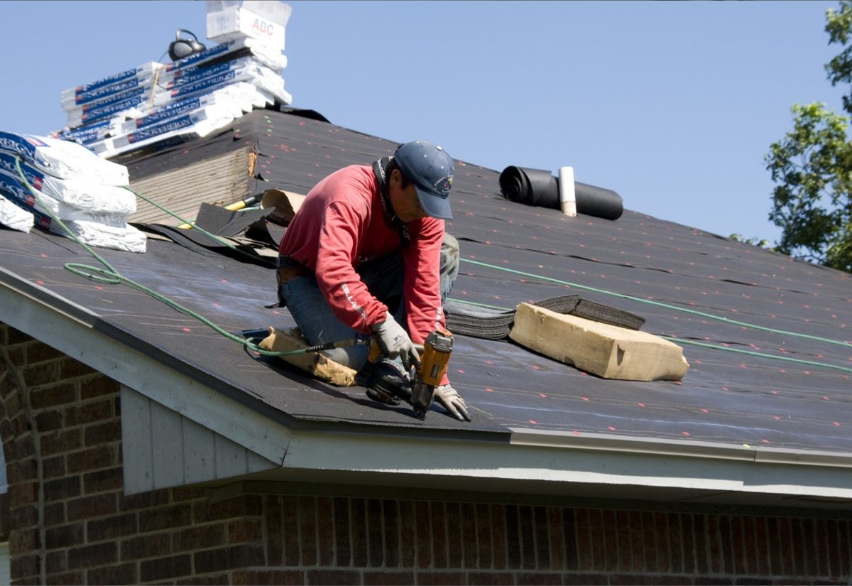 TRC roofer installing new shingles